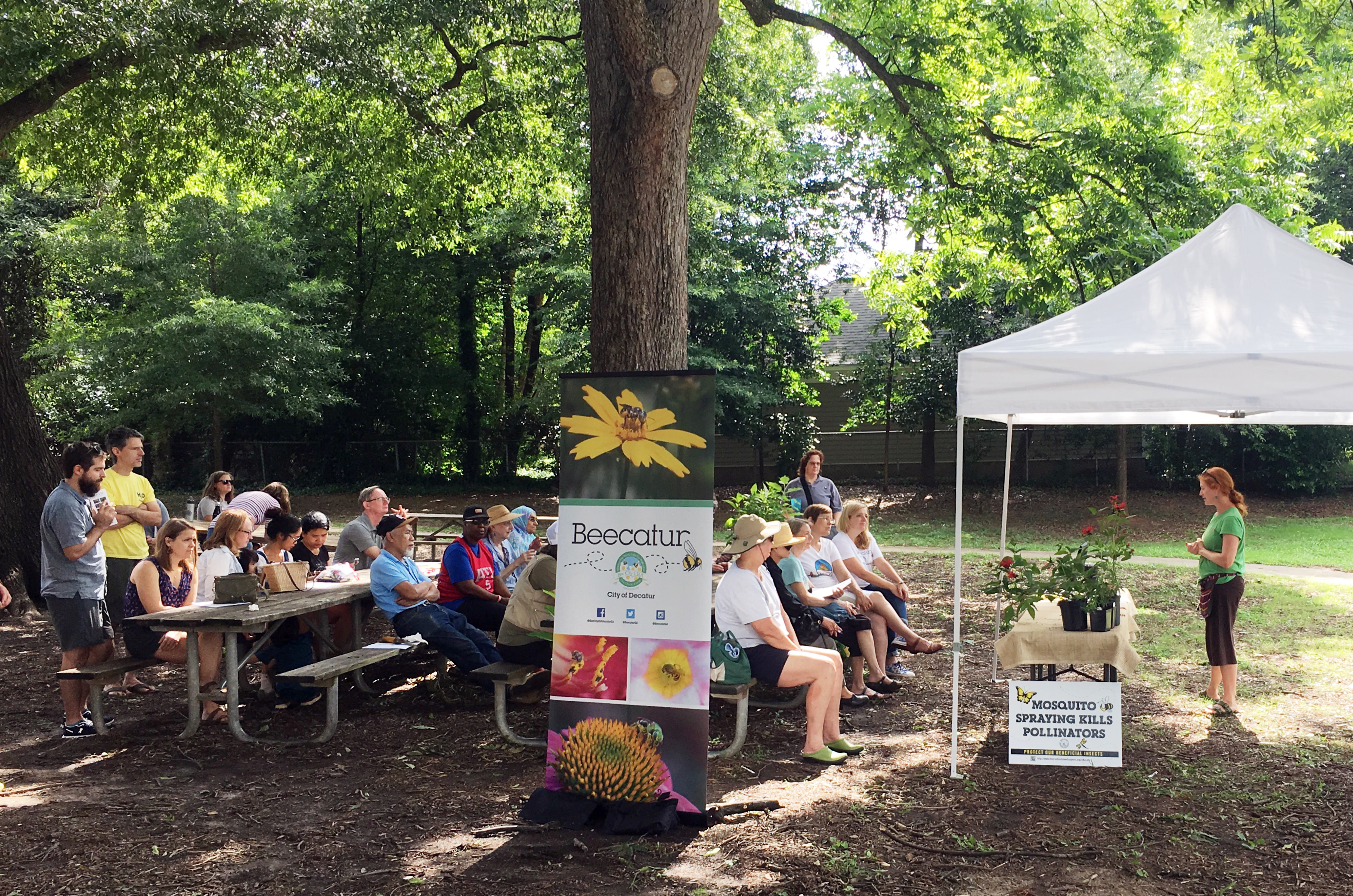 A group of local community members gathers to listen to a presentation about using native plants.