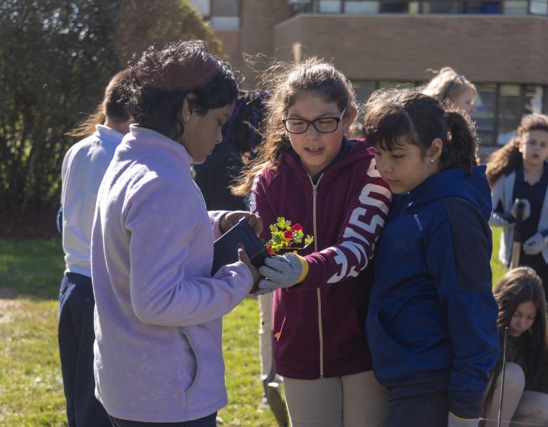 Young community scientists planting.