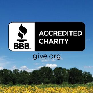 The BBB Accredited Charity symbol is imposed over a picture of a flowering meadow. (Photo: John Wolchesky)