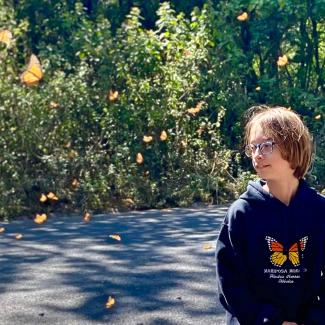 Noah Raven surrounded by flying monarch butterflies