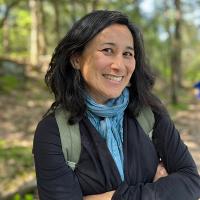 Mia Park posed in front of trees