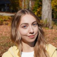 Olivia Matise outside amongst the autumn leaves